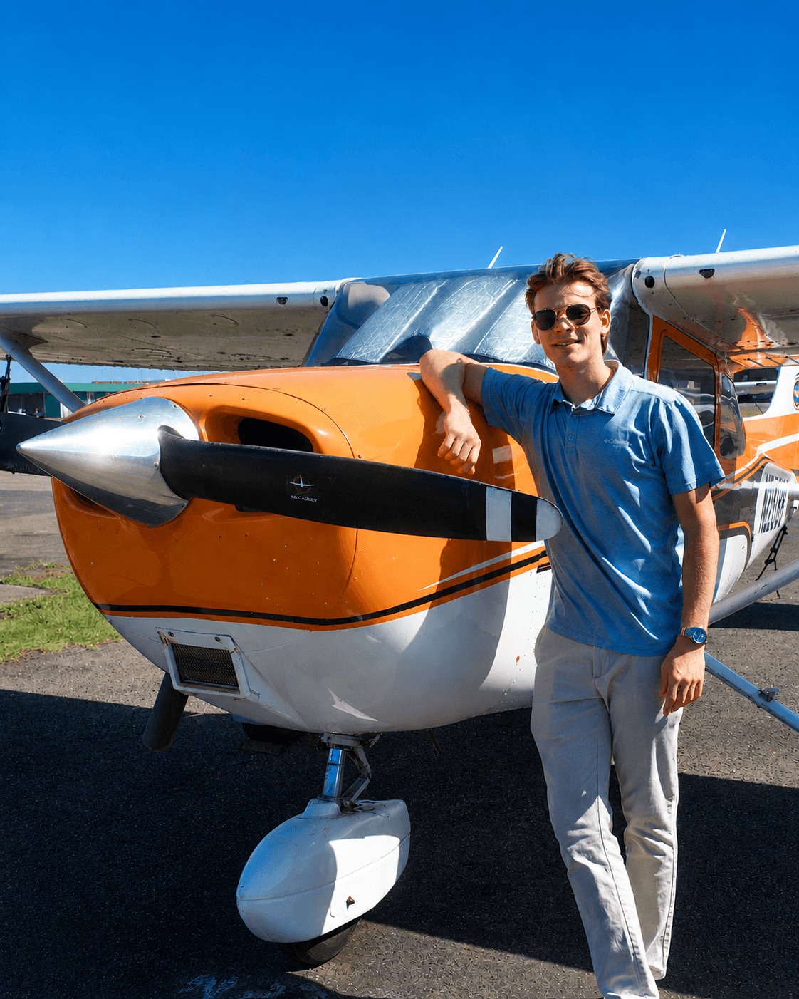 Pilot ready for departure beside a charter aircraft